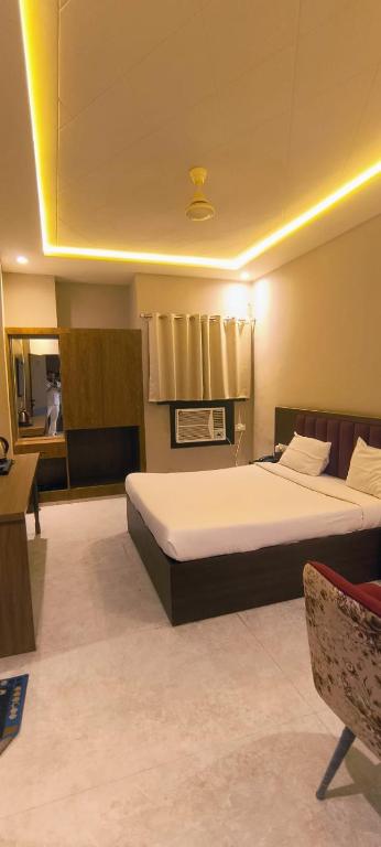 a bedroom with a large bed in a room at hotel grand vk #Ac family rooms#free wifi#free parking in Agra
