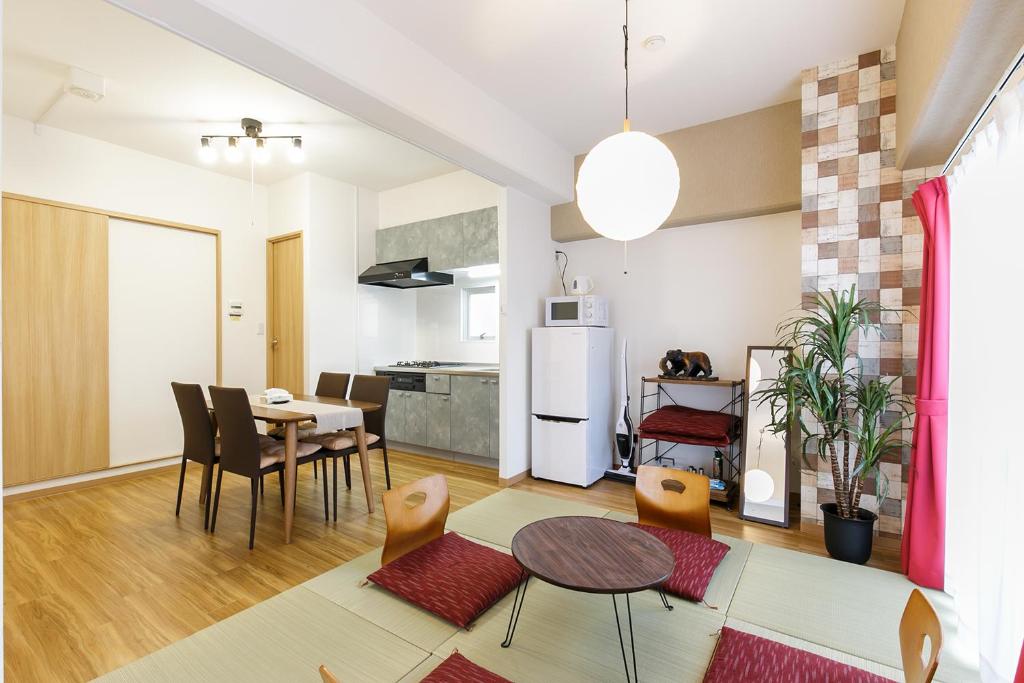a kitchen and living room with a table and chairs at アパートメントホテル名古屋高畑 無料駐車場付 in Shimono-ishikichō
