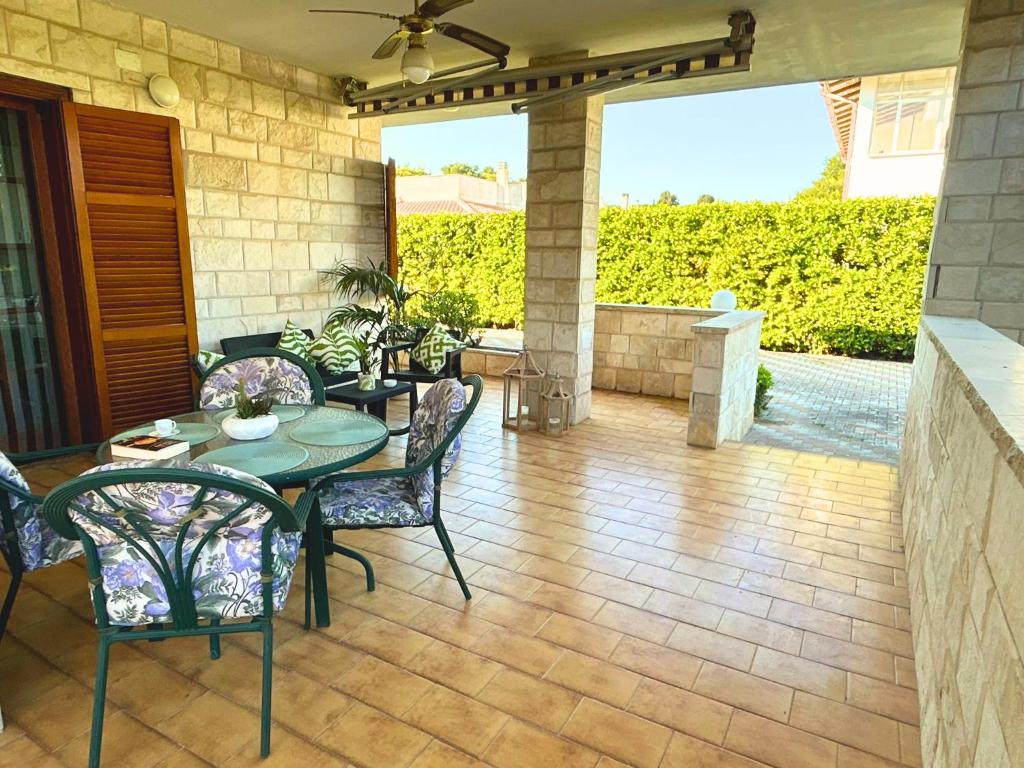 a patio with a table and chairs on a patio at Casa Vacanze Villa Chiara in San Vito