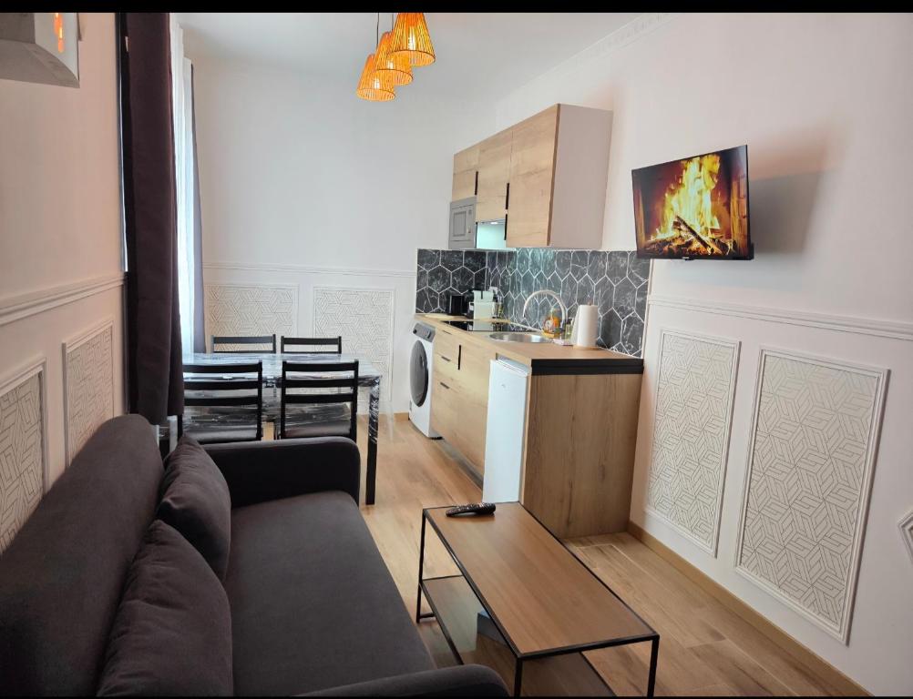 a living room with a couch and a kitchen at White House in Étretat