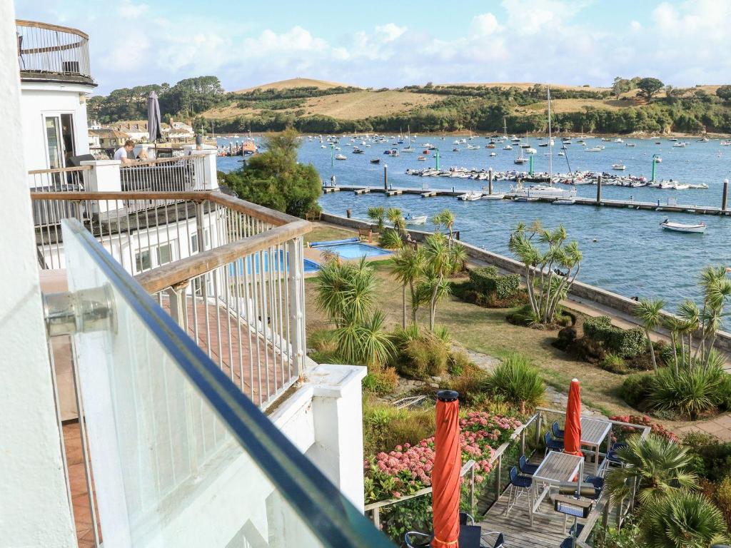 a balcony with a view of a harbor with boats at 24 The Salcombe in Salcombe