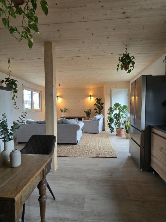 a living room with couches and a table in a room at Bodensee Living Ferienwohnung Wald in Wald