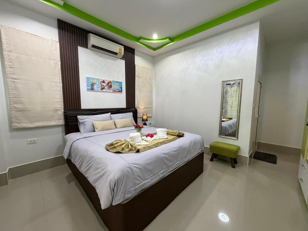 a bedroom with a large bed in a room at Khaolak Beachhouse Kelolo in Khao Lak