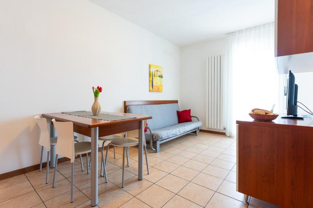 a living room with a table and a couch at Farnie Lido Altanea in Caorle