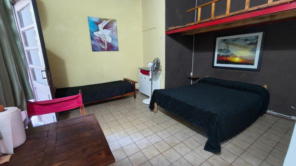 a room with a bedroom with a bed and a table at Departamento PB 2 Centro Pileta in Formosa