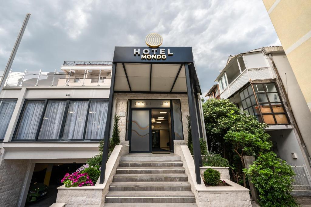 a hotel with a sign on the front of a building at Hotel Mondo in Budva