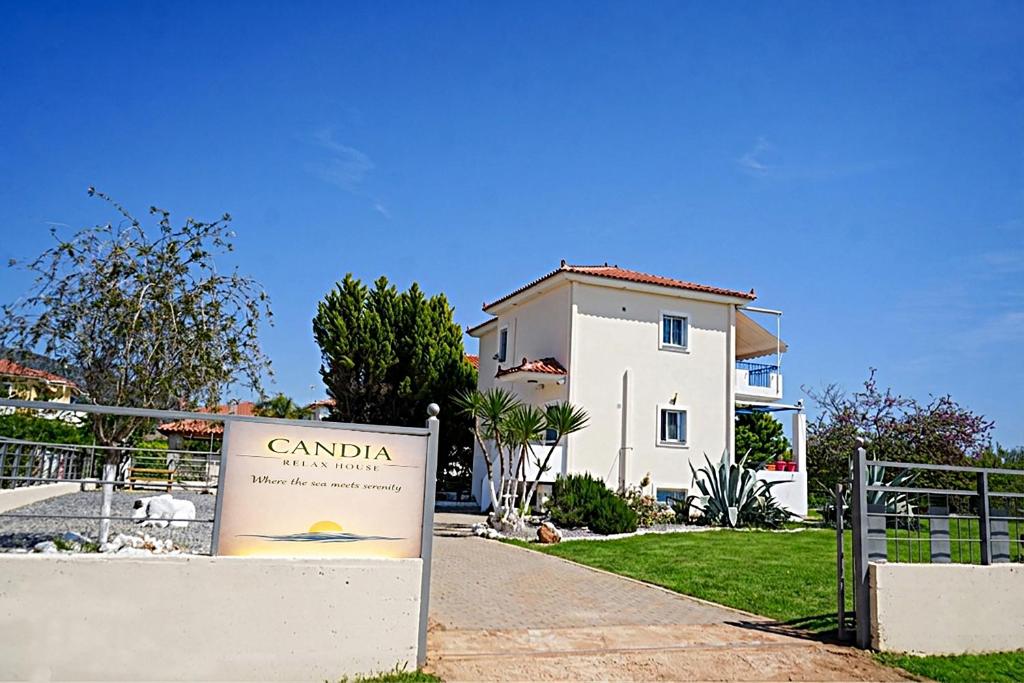 a house with a sign in front of it at Candia Relax House in Kandia