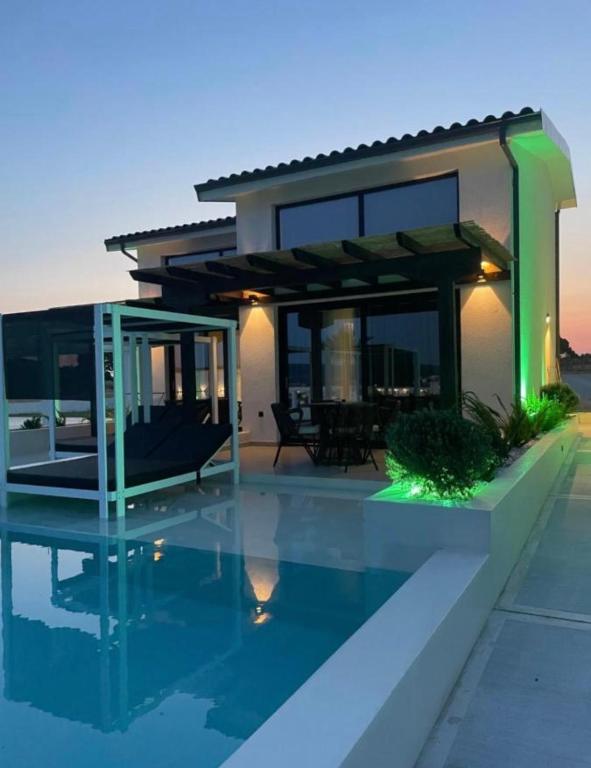 a house with a pool in front of it at Villa Relax in Kallithea Halkidikis