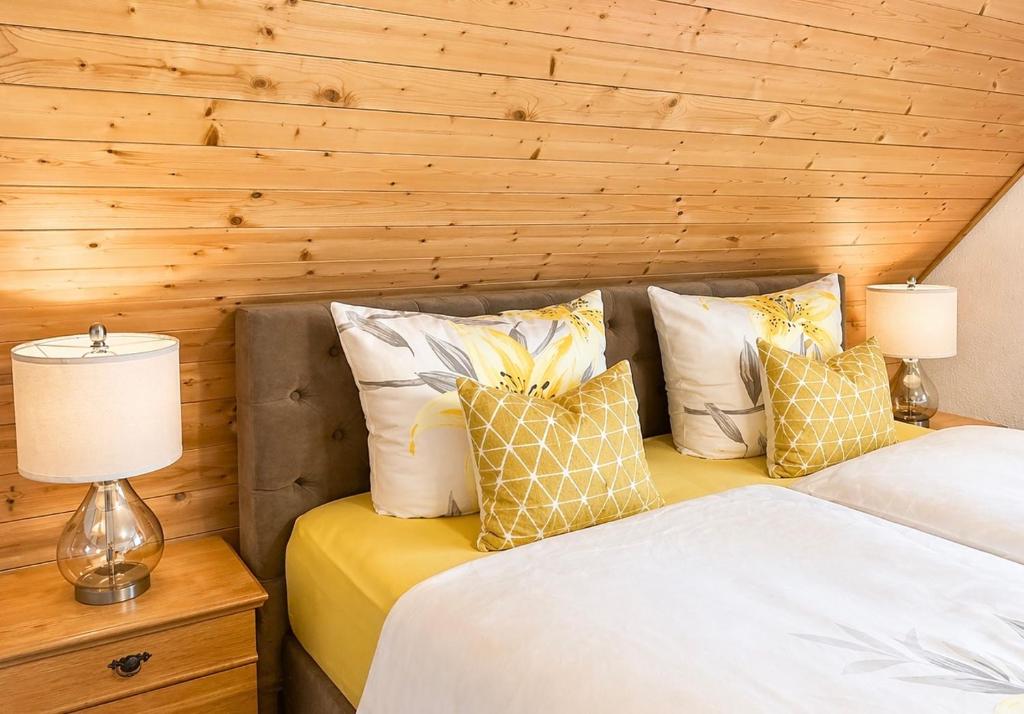 two beds in a room with wooden walls at Ferienhaus mit 3 Apartments - Belle Apartment - Top-Lage, Sauna, HS-Card in Feldberg