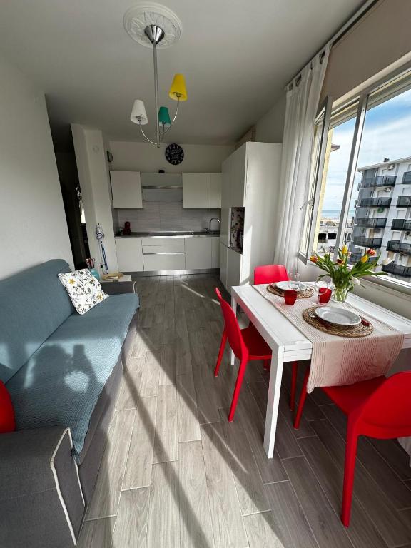 a kitchen and living room with a table and a couch at Bibione Beach Home in Bibione