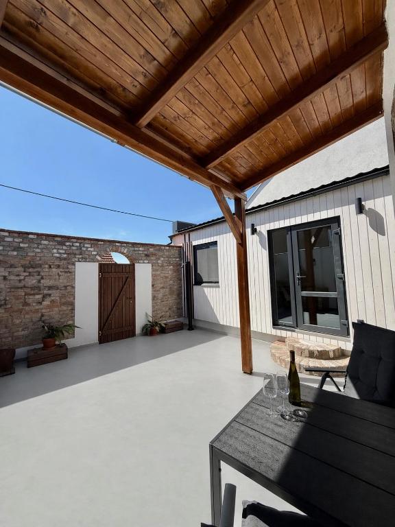 an outdoor patio with a wooden pergola at Apartmán My dva a terasa in Valtice