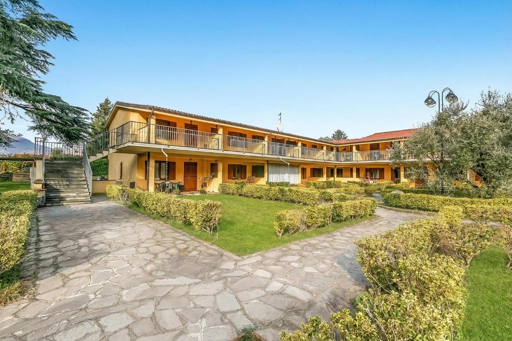 an exterior view of a building with a courtyard at Residence La Perla with Shared Pool in Monte Isola