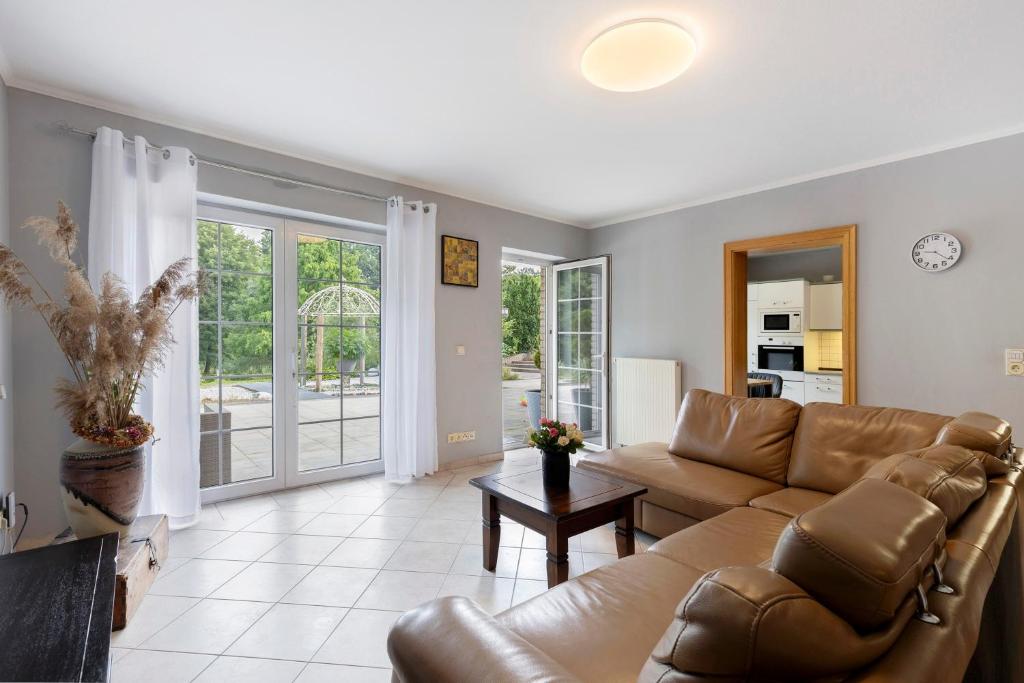 a living room with a couch and a table at Fewo am Wasser 2 in Groß Lindow