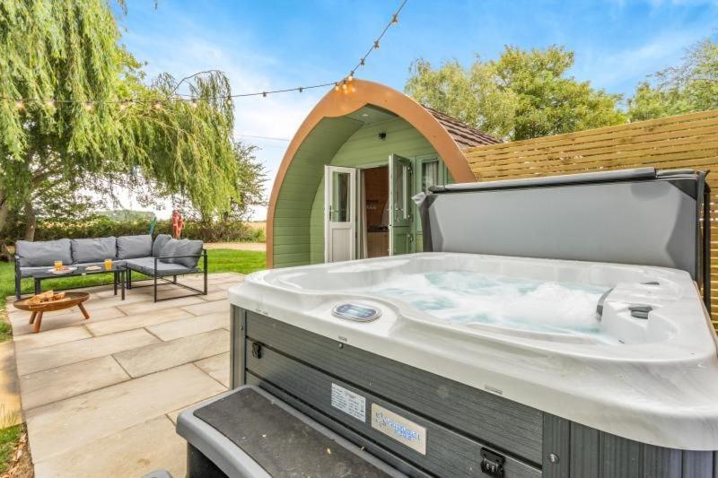 a hot tub in the backyard of a house at 1 Willowmere lakeside Hideaway in Baston