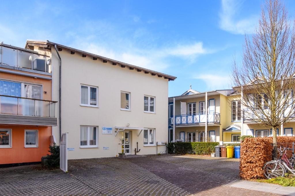 a row of houses in a parking lot at Haus Seewind Warnemünde in Rostock