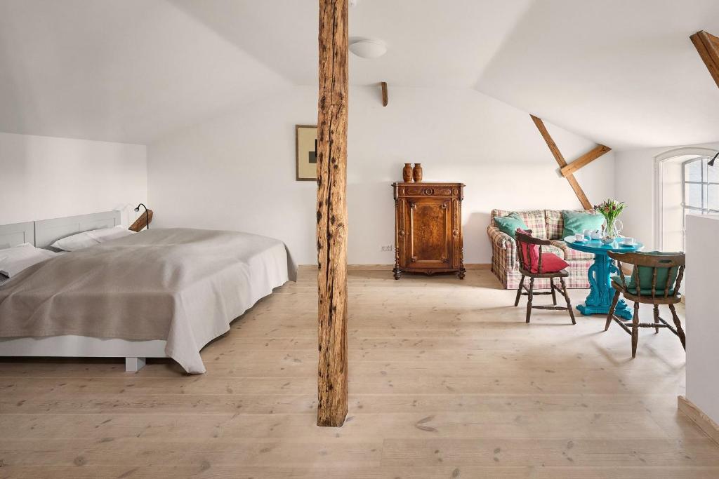 a bedroom with a bed and a table with chairs at Hay Loft - Flensburger Förde in Westerholz