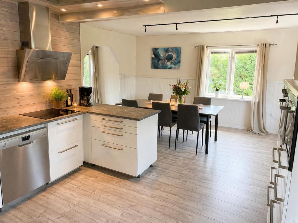a kitchen and dining room with a table and chairs at Only 150 m to the nearest lake and 2,5 km to the top of Isaberg in Hestra