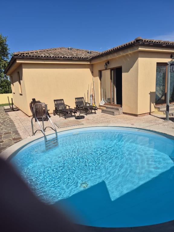 a large swimming pool in front of a house at Villa Aria in Marčana