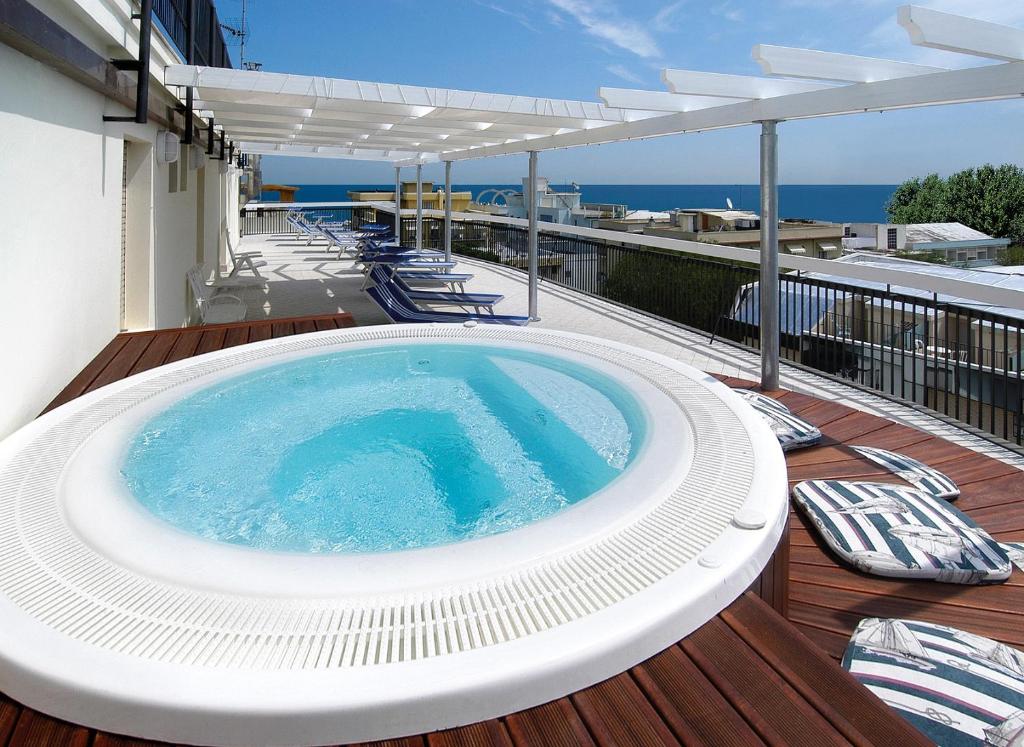 a hot tub on the deck of a house at Hotel Brig in Cattolica