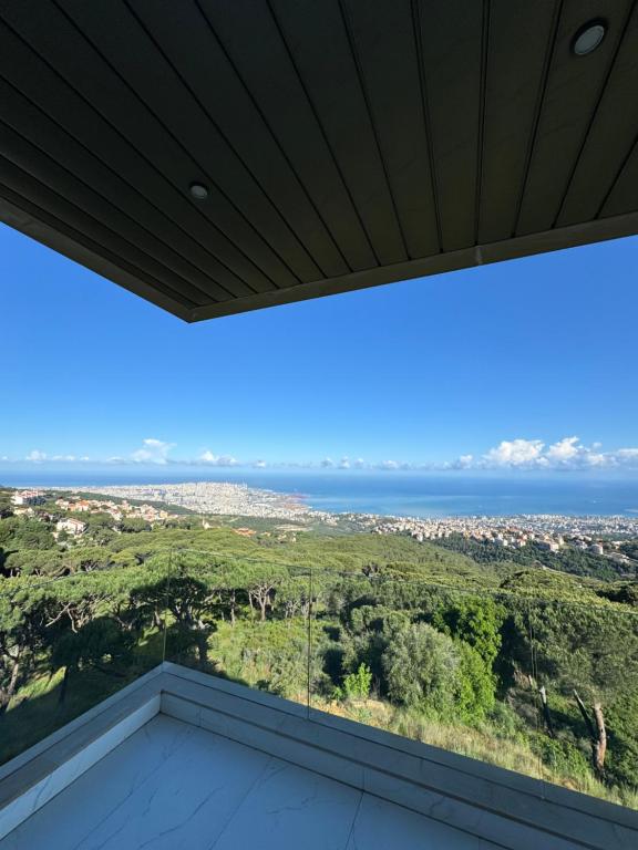 a view of the ocean from the balcony of a house at Brummana Views in Broummana
