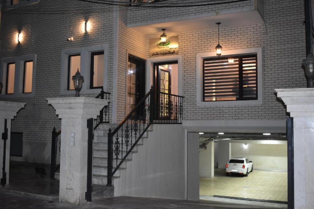 a white car is parked in a parking garage at Motel Victoria Sky in Erbil