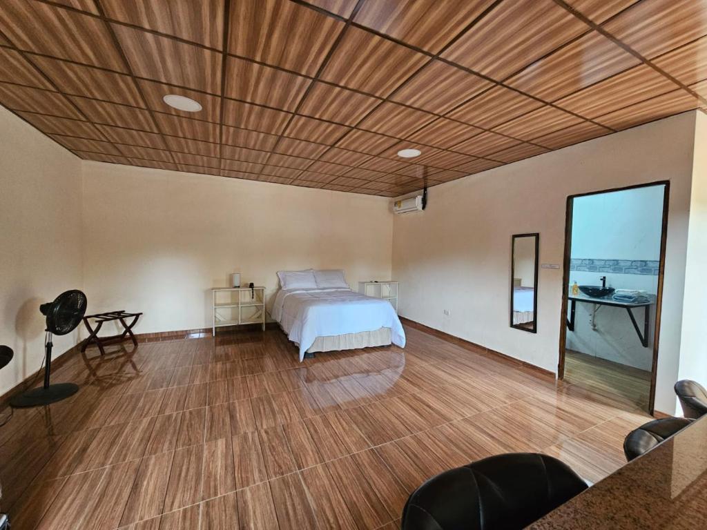 a bedroom with a bed and a wooden ceiling at Tocumen Comfort Stay in Aserrío