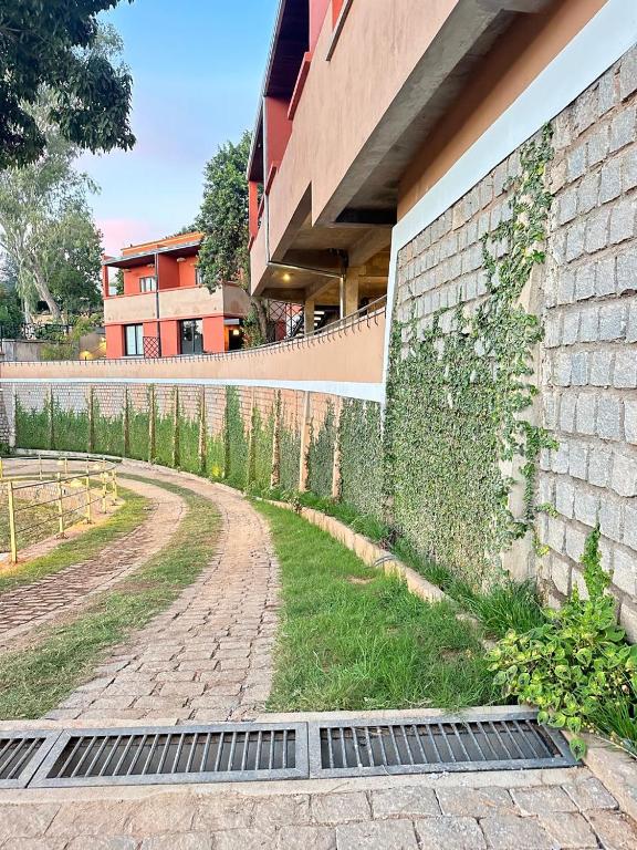 a drain in the grass next to a building at Résidence Marotia in Antananarivo