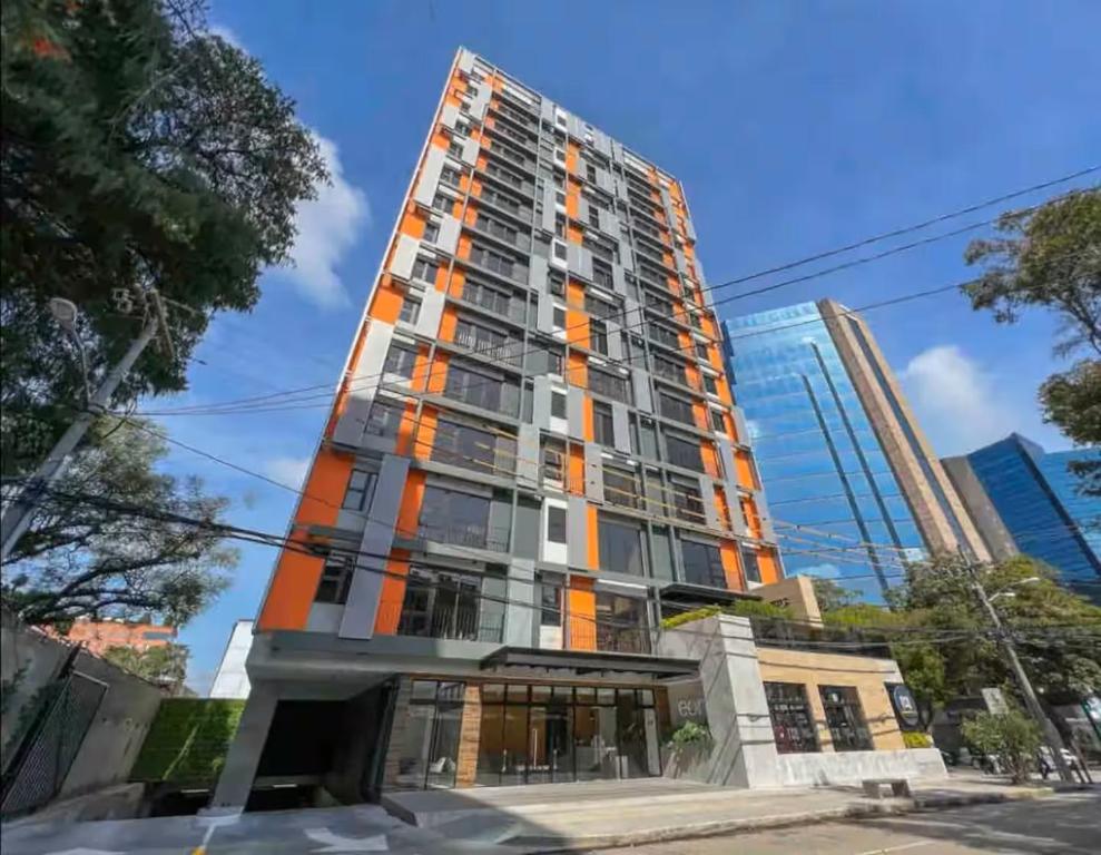 a tall building with an orange at EON One Bedroom Apartment 1305 in Estación Pamplona