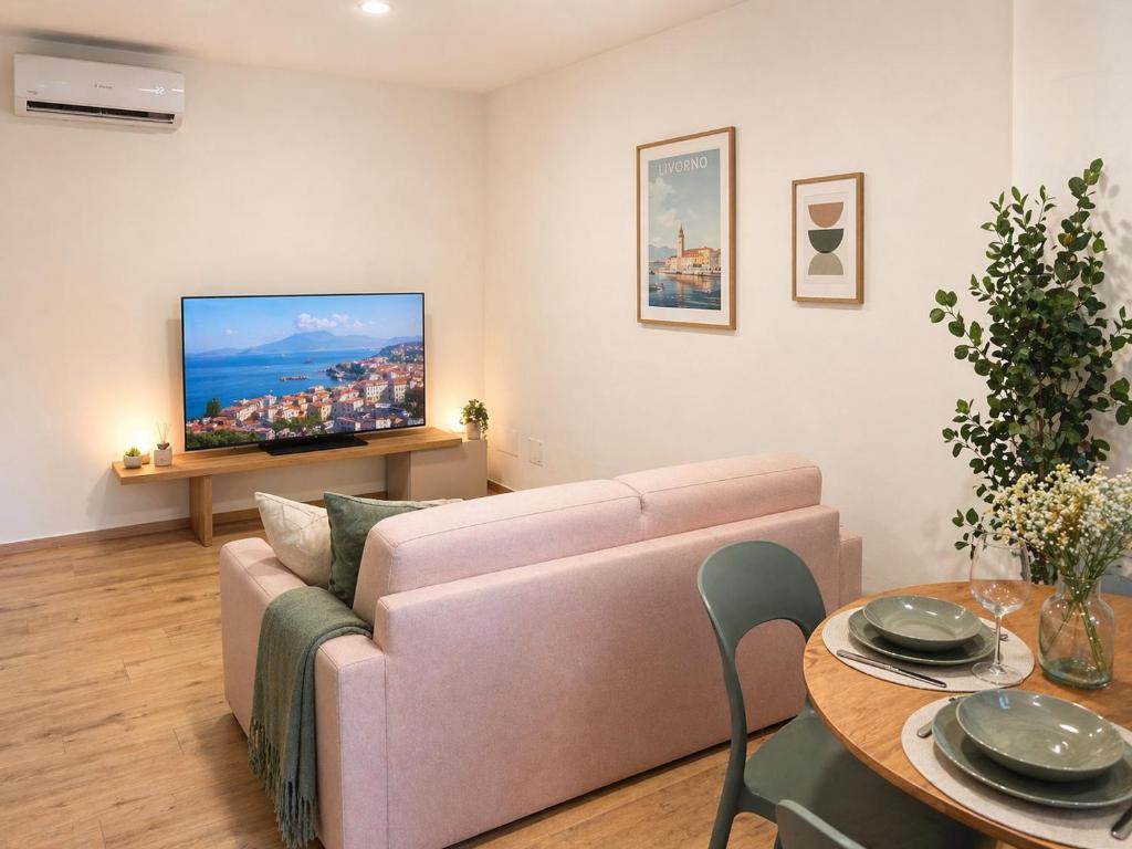 a living room with a couch and a table at I Bimbi - Suite Apartment in Livorno