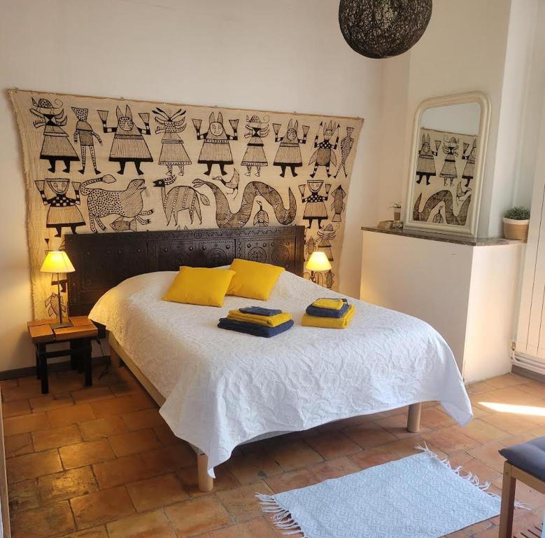 a bedroom with a bed with two towels on it at le rocher de Sampzon in Sampzon