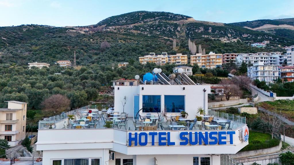 a hotel sunset with mountains in the background at Hotel SUNSET GL in Vlorë