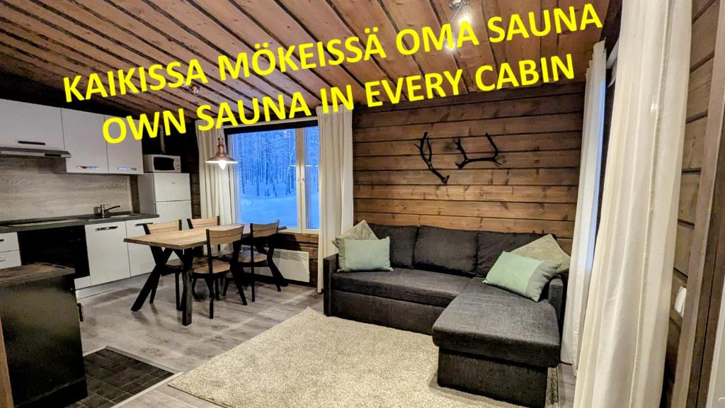a living room with a couch and a table at North Frontier Cabins in Saariselka