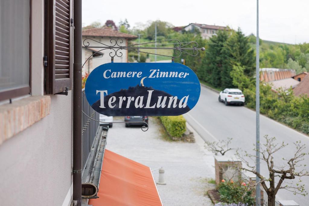 a sign on the side of a building next to a street at Terraluna in Monforte dʼAlba