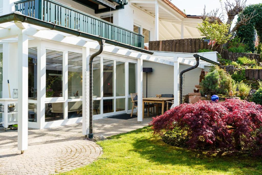 a house with white columns and a patio at Alm-Atelier in Durbach