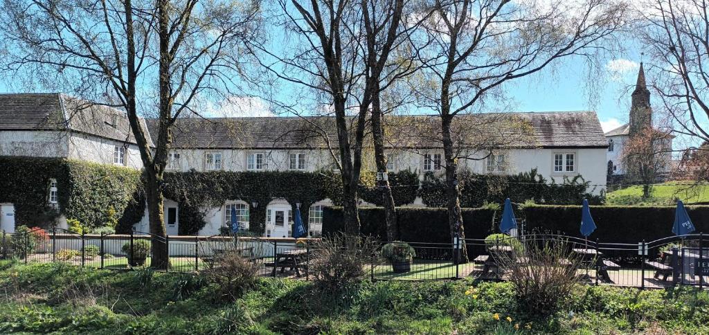 a large white building with trees in front of it at Eglinton Arms Hotel, BW Premier Collection in East Kilbride
