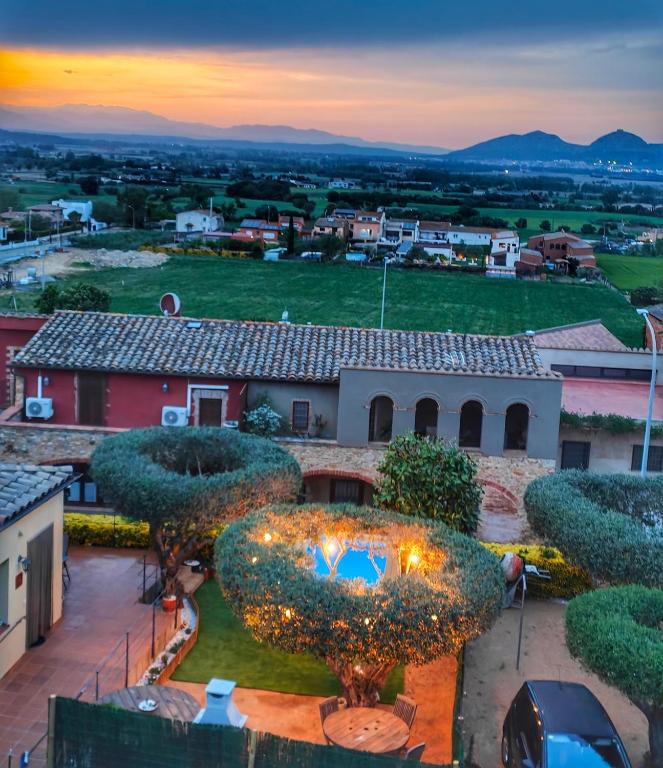 an aerial view of a house with a large pig statue at Can Sais in Pals