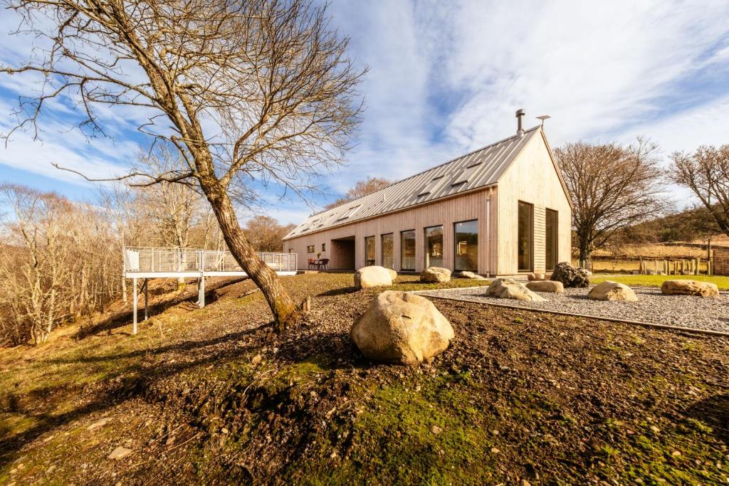a house with a tree in front of it at Larch House in Blairgowrie