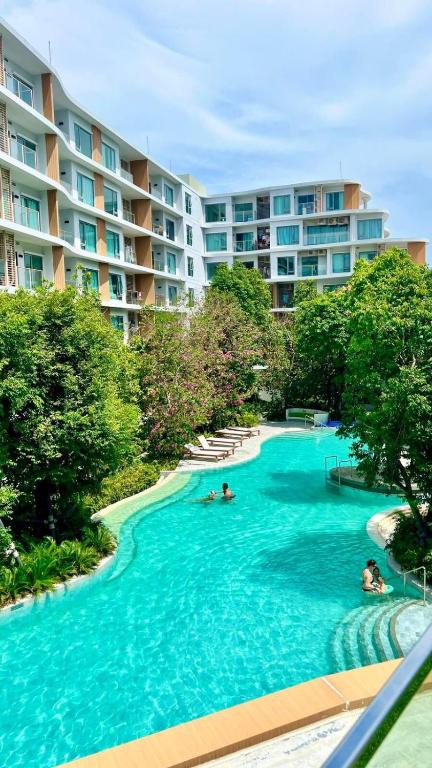 a swimming pool in front of a large apartment building at Phyll Condominium Luxury 301 2bedroom, Phuket in Ban Rangeng