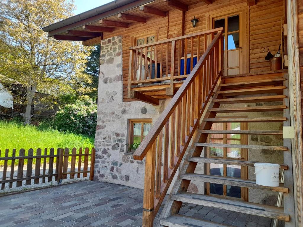 a wooden staircase leading up to a cabin with a porch at Chalet Dolomiti Trentino in Sant’Orsola