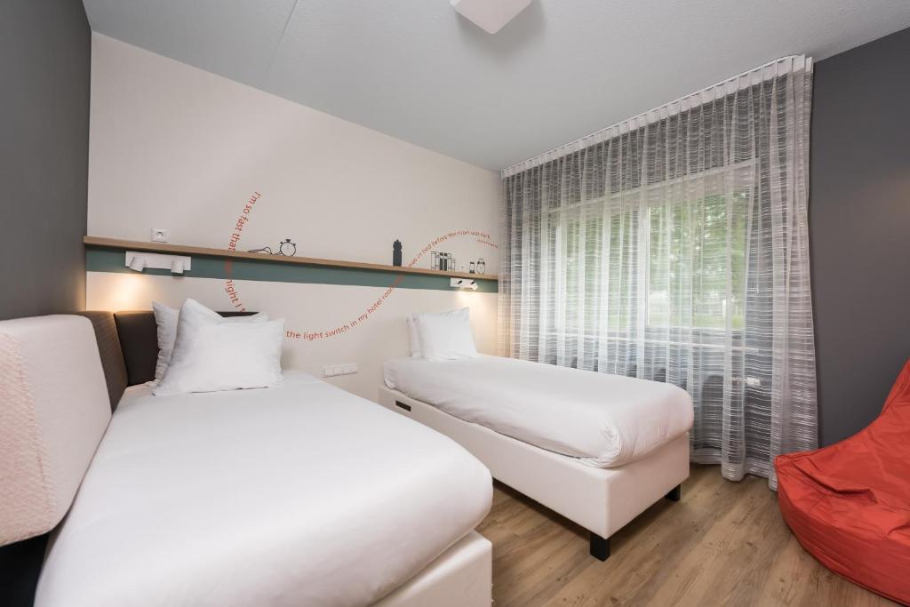 Postel nebo postele na pokoji v ubytování Hotel Papendal