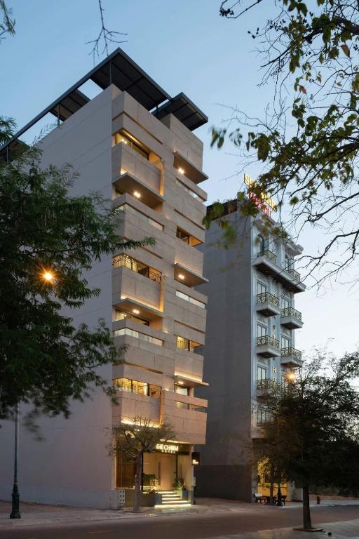 a tall building with lights on the side of it at The Charm Hotel Phan Thiet in Ấp Bình Hưng