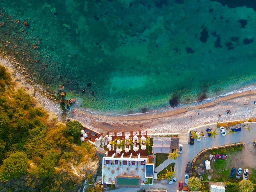 an overhead view of a beach with a building at Oniro by Iliria Palace in Himare