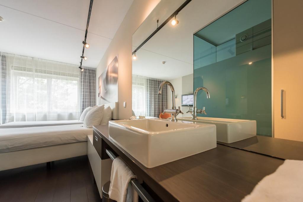 Postel nebo postele na pokoji v ubytování Hotel Papendal