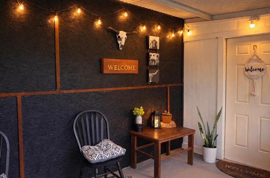a room with a table and a cow head on the wall at Western Studio in Houston