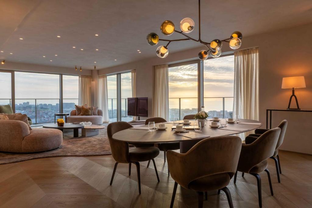 a dining room with a table and chairs in a living room at O'Ciel 24 - Exceptional 24th floor Residence - Ostend in Ostend