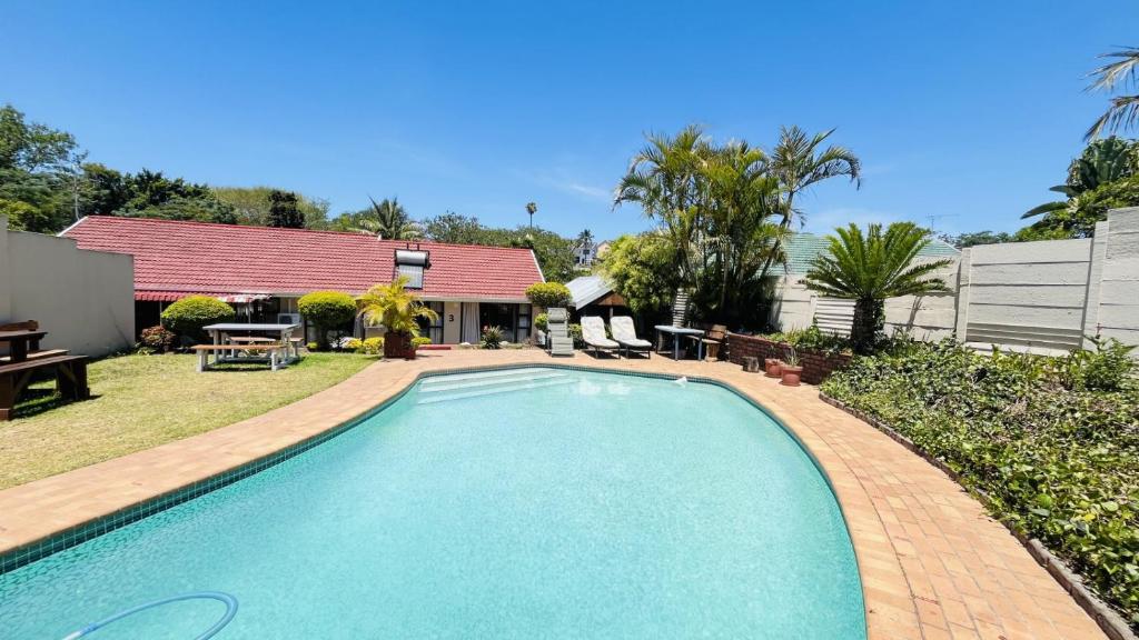 a swimming pool in the backyard of a house at Yolonwabo Bed & Beakfast in East London