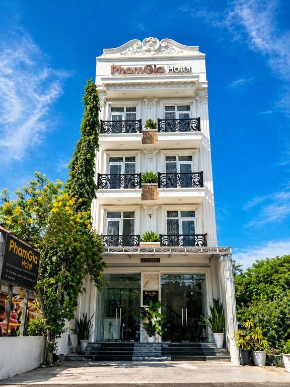 a white building with a sign on it at Pham Gia Hotel Mui Ne in Mui Ne