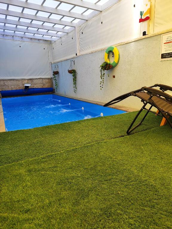 a large indoor swimming pool in a building at אחוזת דולב Dolev estate הווילה in Zanoaẖ