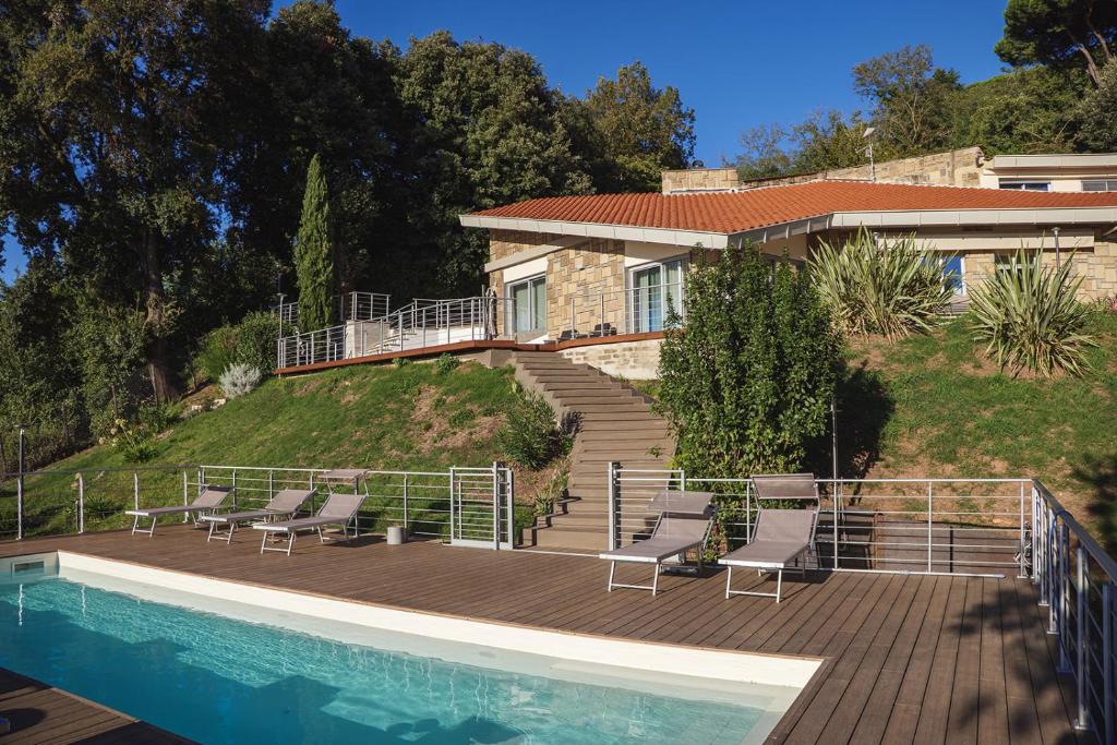 a house with a deck and a swimming pool at VILLA GIULIA 8, Emma Villas in Nemi