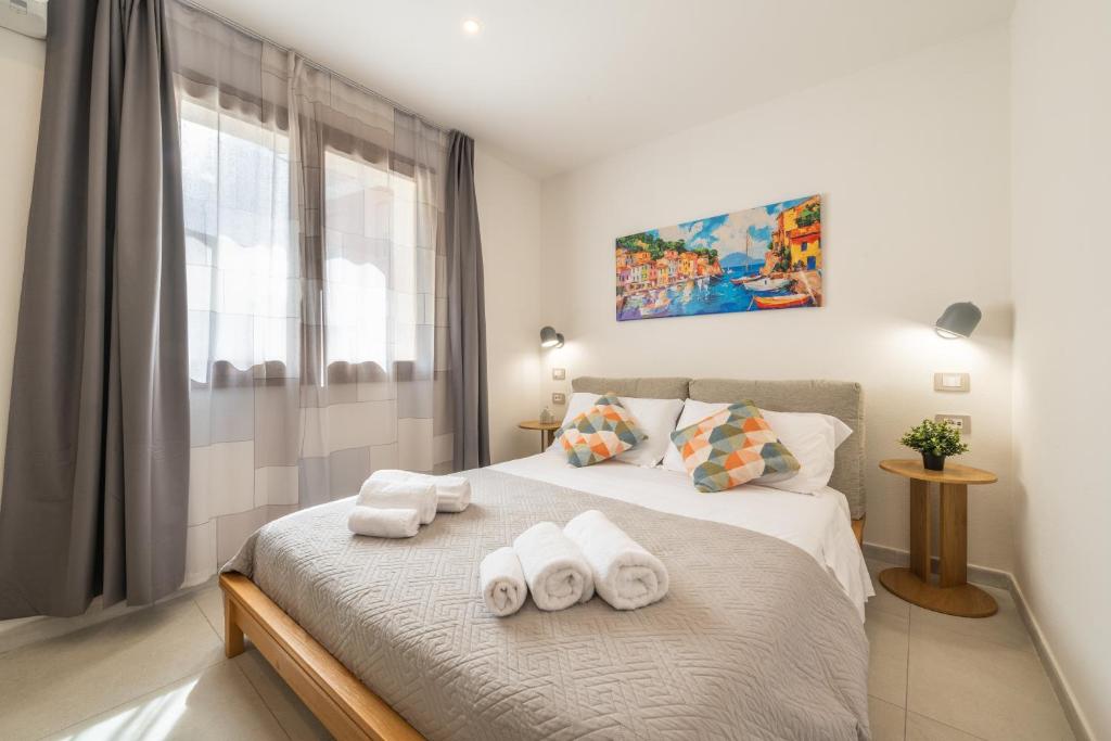 a bedroom with a bed with towels on it at Domus Luna in Teulada